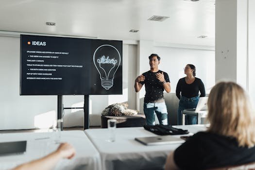 Two colleagues giving a dynamic business presentation in a modern office environment, engaging their audience.