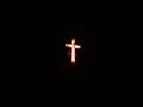 Glowing cross against a dark background from Faisalabad, Pakistan.
