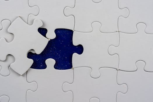 An artistic close-up of a puzzle with one missing piece revealing a contrasting background.